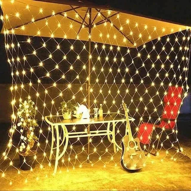 Net Mesh Solar Fairy Lights illuminating an outdoor patio setup with warm white LED lights.