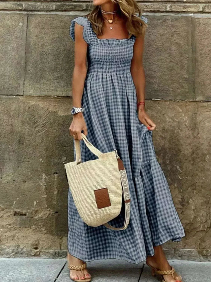 Plus Size Gingham Smocked Ruffle Maxi Dress with flowing skirt and ruffle accents from Hot Topic Goods