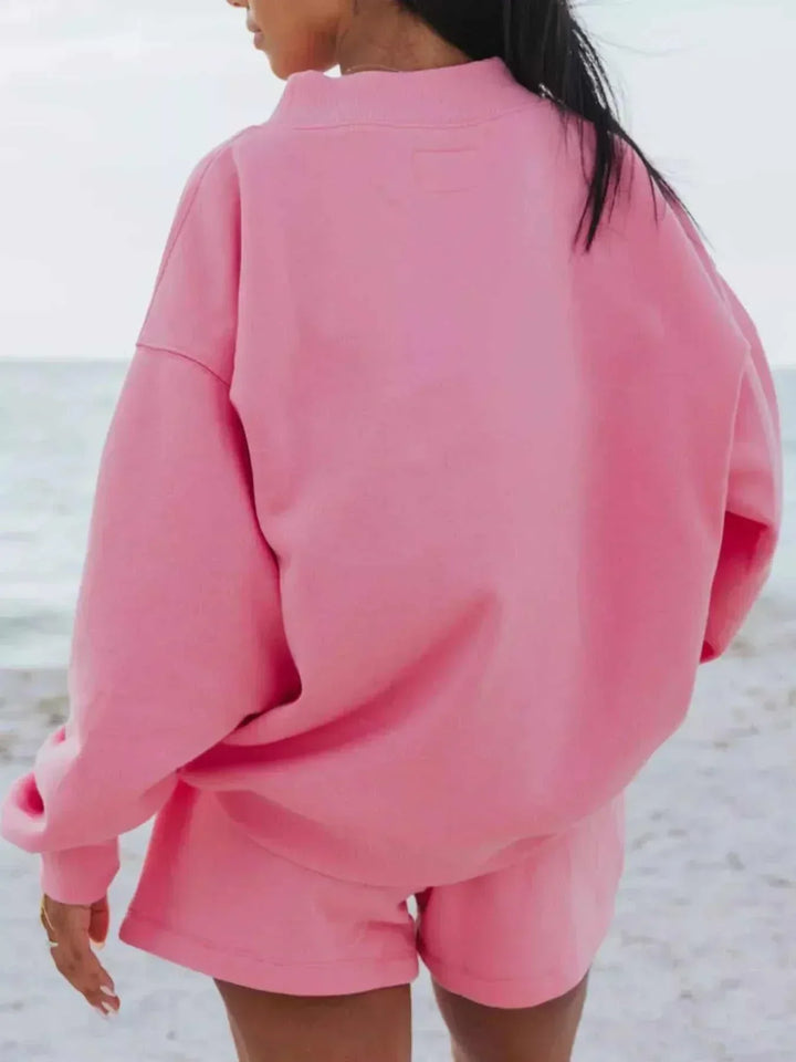 Woman wearing relaxed sweatshirt and matching shorts set in soft breathable fabric from Hot Topic Goods