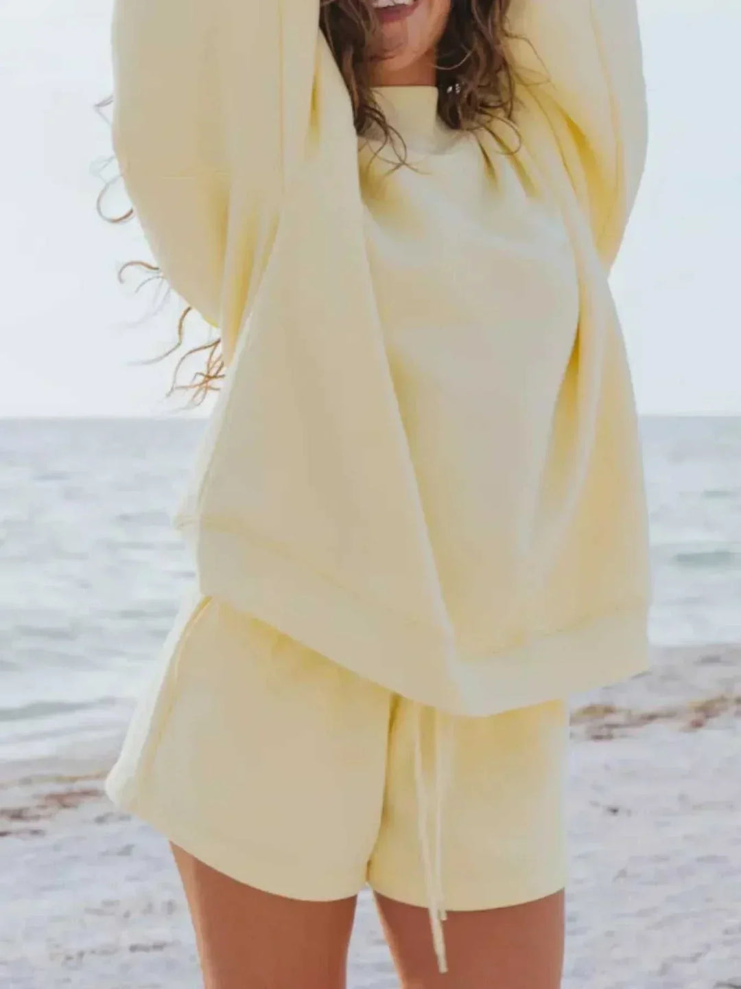 Woman wearing relaxed sweatshirt and matching shorts set from Hot Topic Goods in soft breathable fabric