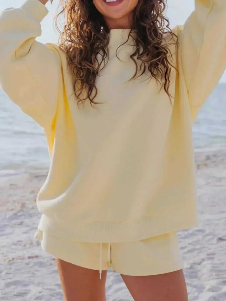 Woman wearing relaxed sweatshirt and matching shorts set from Hot Topic Goods in casual lounge style