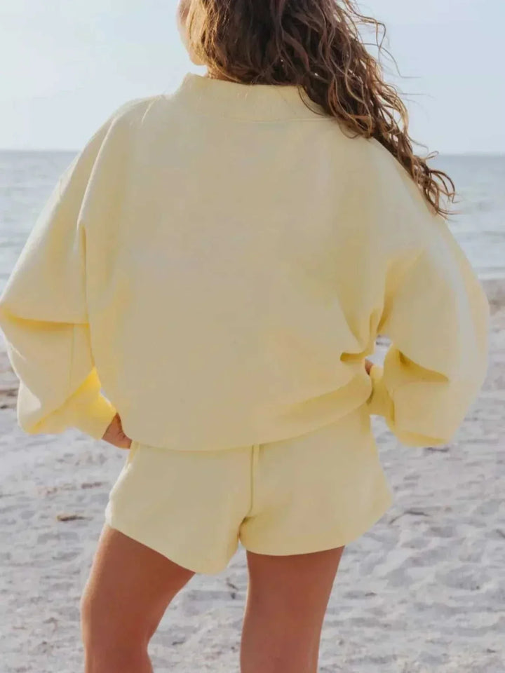 Woman wearing a relaxed sweatshirt and matching shorts set from Hot Topic Goods in casual indoor setting