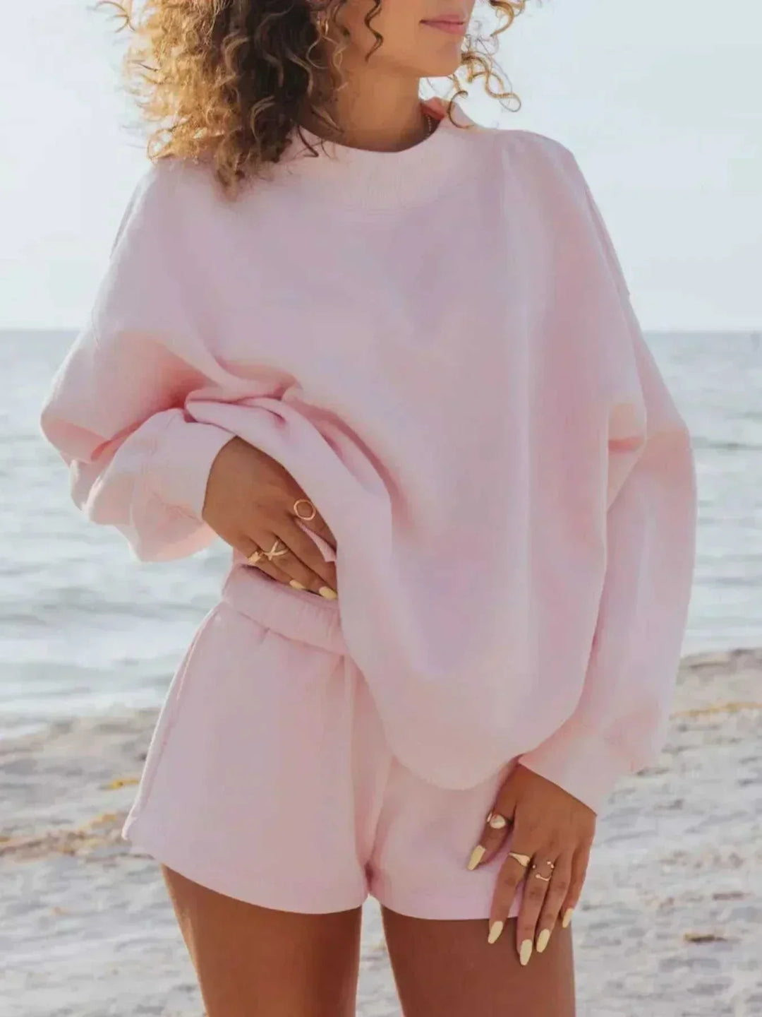 Women wearing relaxed sweatshirt and matching shorts set from Hot Topic Goods in casual setting