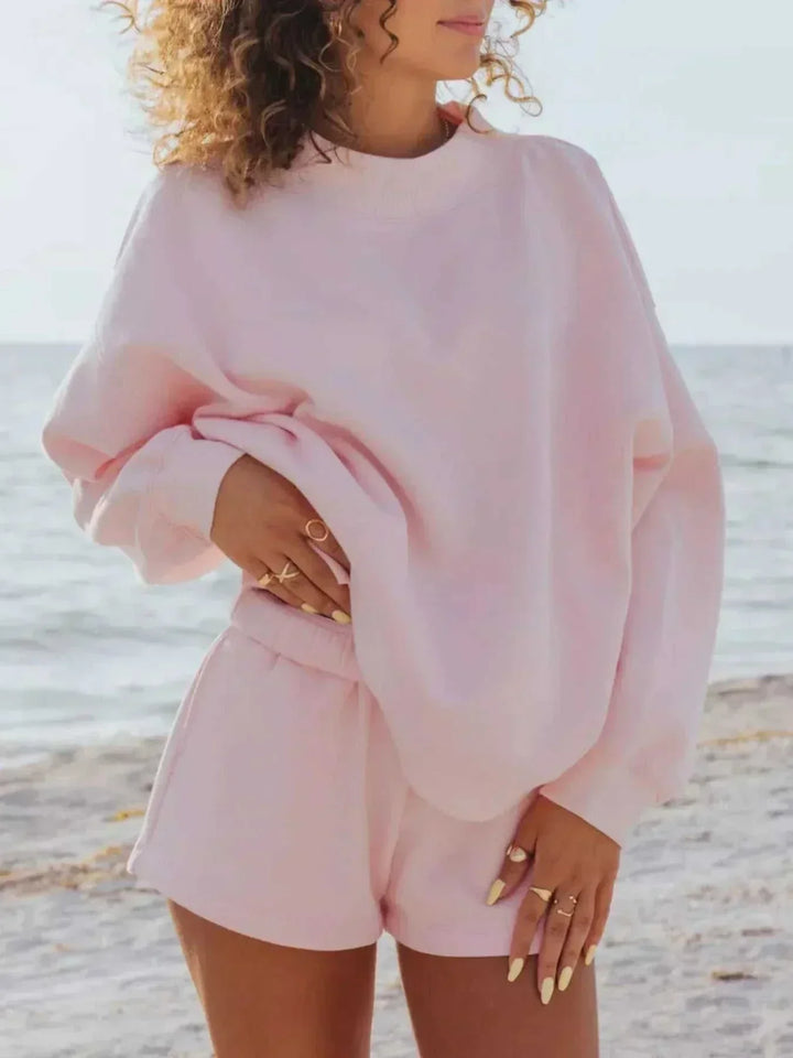 Women wearing relaxed sweatshirt and matching shorts set from Hot Topic Goods in casual setting