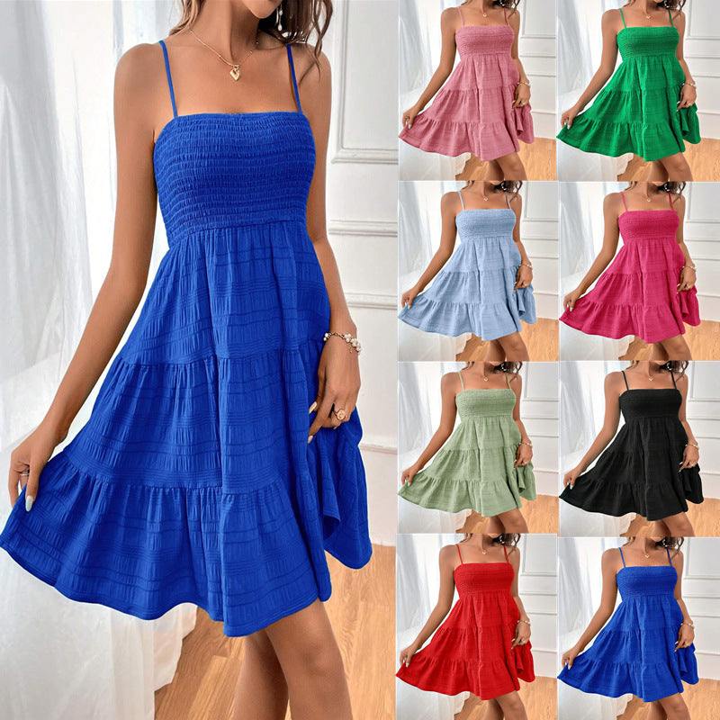 Woman wearing a square neck pleated beach sundress walking on the beach