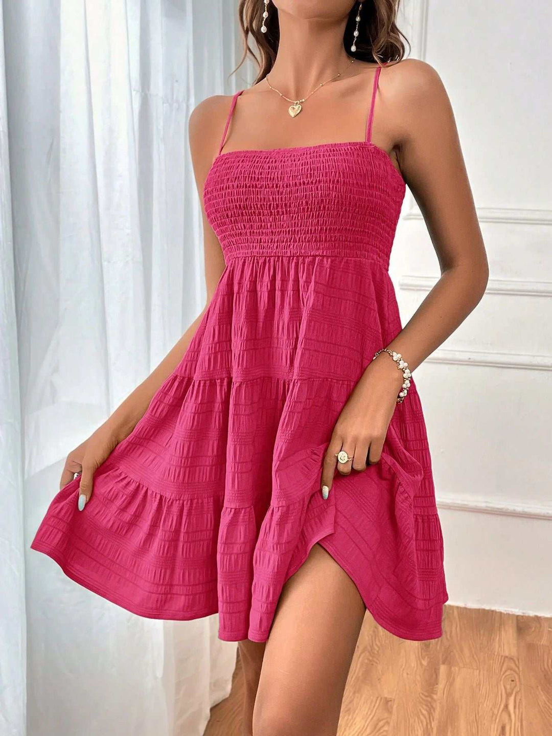 Woman wearing a square neck pleated beach sundress in lightweight fabric