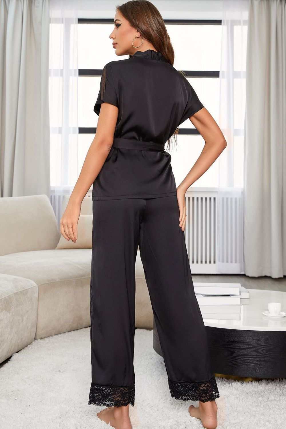Woman wearing Women's Surplice Tie Waist Pajama Set from Hot Topic Goods in relaxed home setting