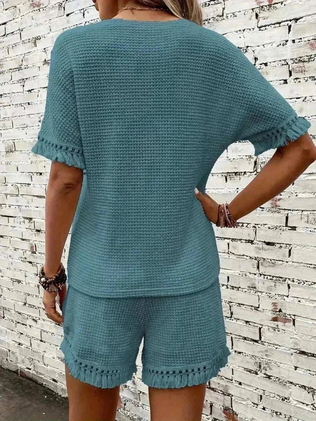Woman wearing Tassel Top &amp; Shorts Set from Hot Topic Goods, stylish two-piece summer outfit with tassel detailing and breathable fabric