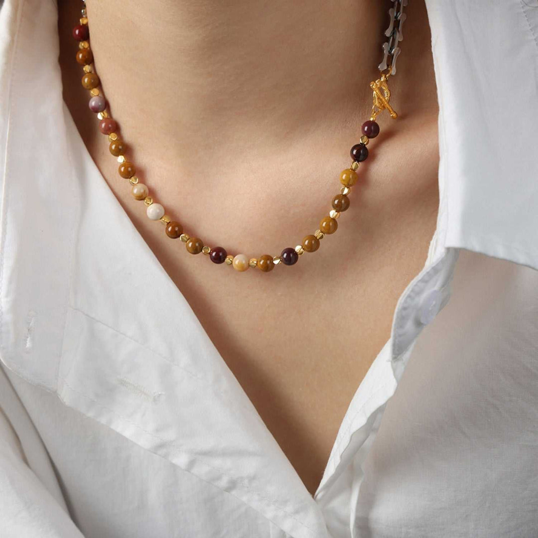 Titanium steel pendant necklace with egg yolk stone centerpiece