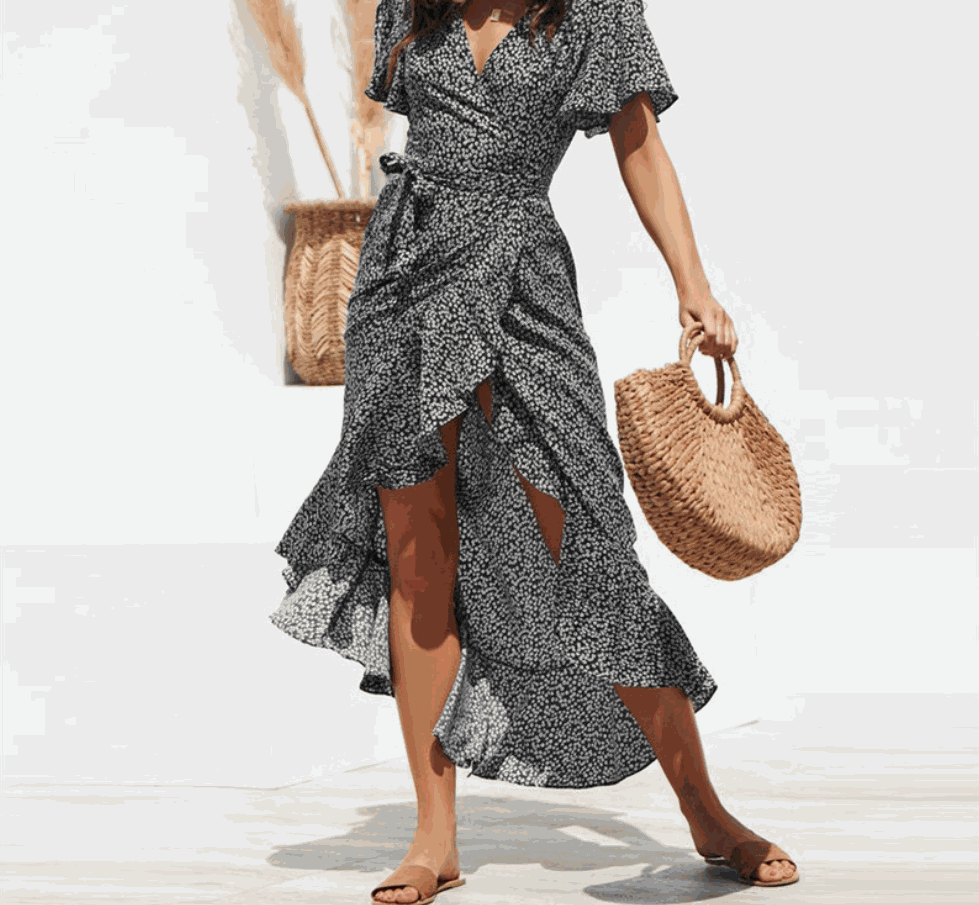 Woman wearing V-neck floral chiffon maxi dress with flowing silhouette and vibrant print