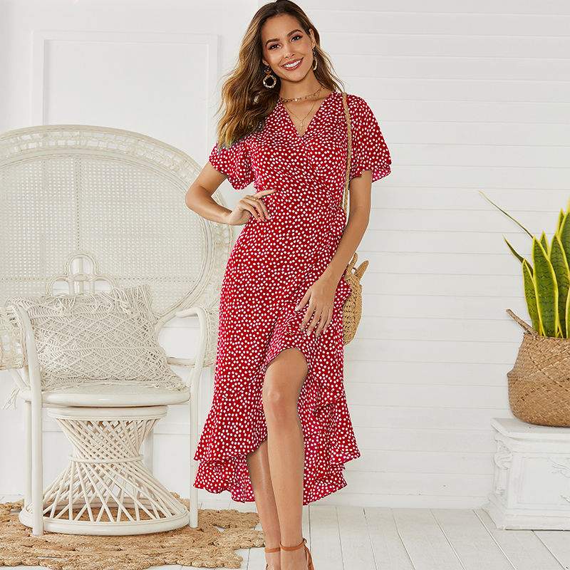 Woman wearing V-neck floral chiffon maxi dress with flowing silhouette and vibrant floral print