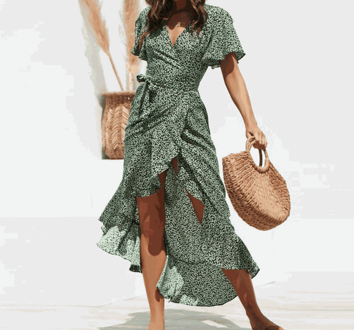 Woman wearing V-neck floral chiffon maxi dress with colorful flower print and flowing silhouette