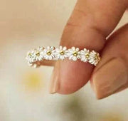 Fidget Spinner Ring with floral design held between fingers.