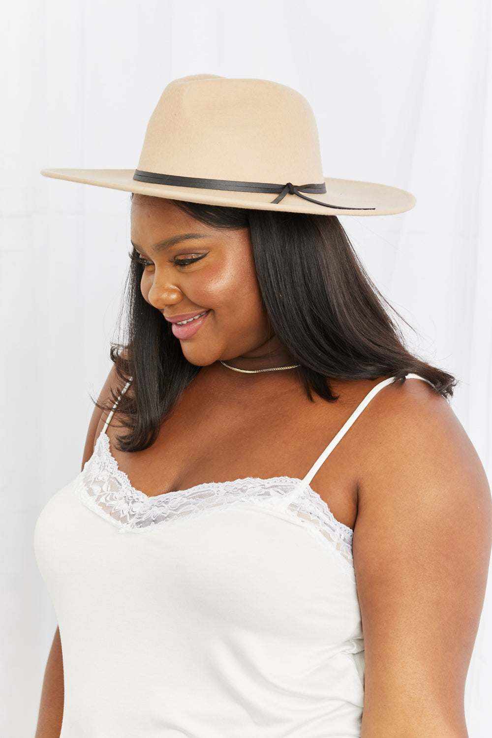 Women’s Classic Fedora Hat in beige with a wide flat brim, dark trim, and small bow accent