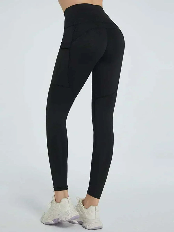 Women’s High-Waisted Leggings in dark green stretch fabric, with a wide high-rise waistband and fitted legs