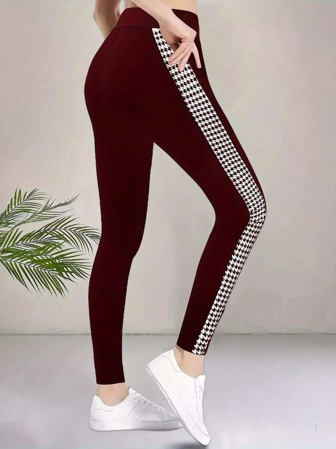 Women’s Houndstooth Leggings in red stretch fabric, with a black-and-white houndstooth stripe down each side.
