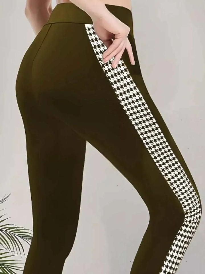 Women’s Houndstooth Leggings in green stretch fabric, with a high waistband and bold black-and-white side stripes.
