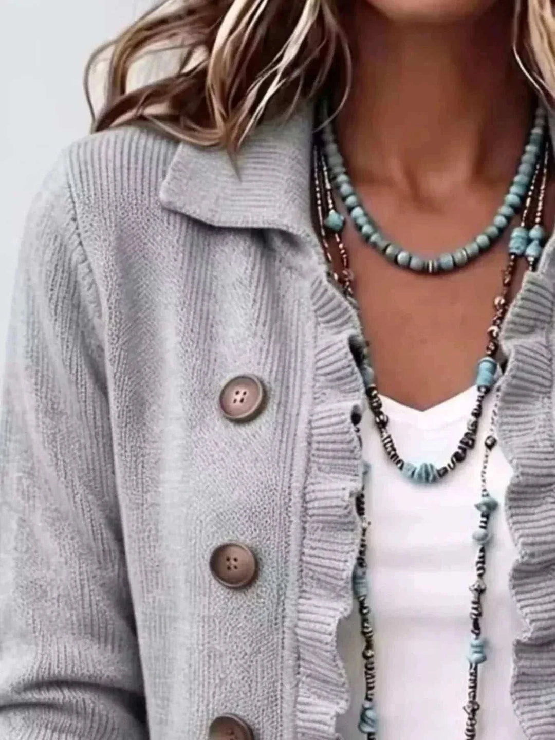 Women’s Plus Size Ruffled Cardigan in light gray knit with ribbed ruffle trim, wide collar, and brown buttons