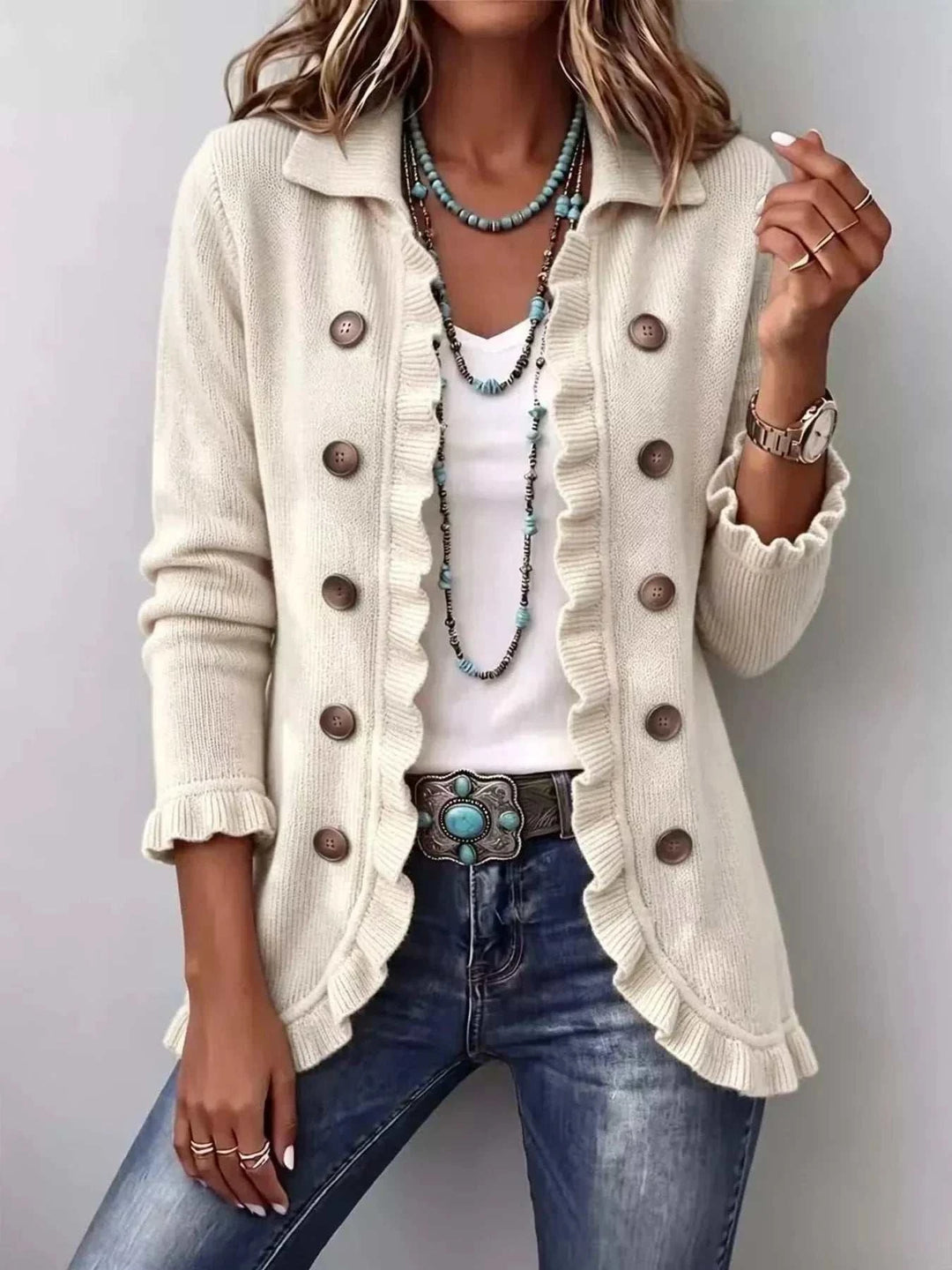 Women’s Plus Size Ruffled Cardigan in ivory knit with a collared neckline, brown buttons, and ruffled edges