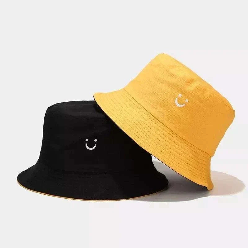 Women’s Smiley Face Bucket Hat in black and yellow cotton with small embroidered smiley faces and stitched brims