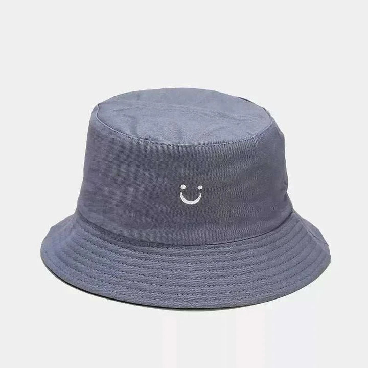 Women’s Smiley Face Bucket Hat in slate gray cotton with a small white embroidered smile and stitched brim