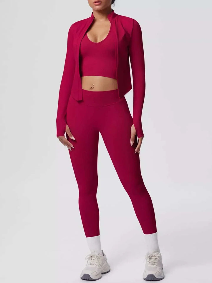 Women’s Three-Piece Activewear Set in burgundy stretch fabric, with a cropped tank, open zip-up jacket, and leggings
