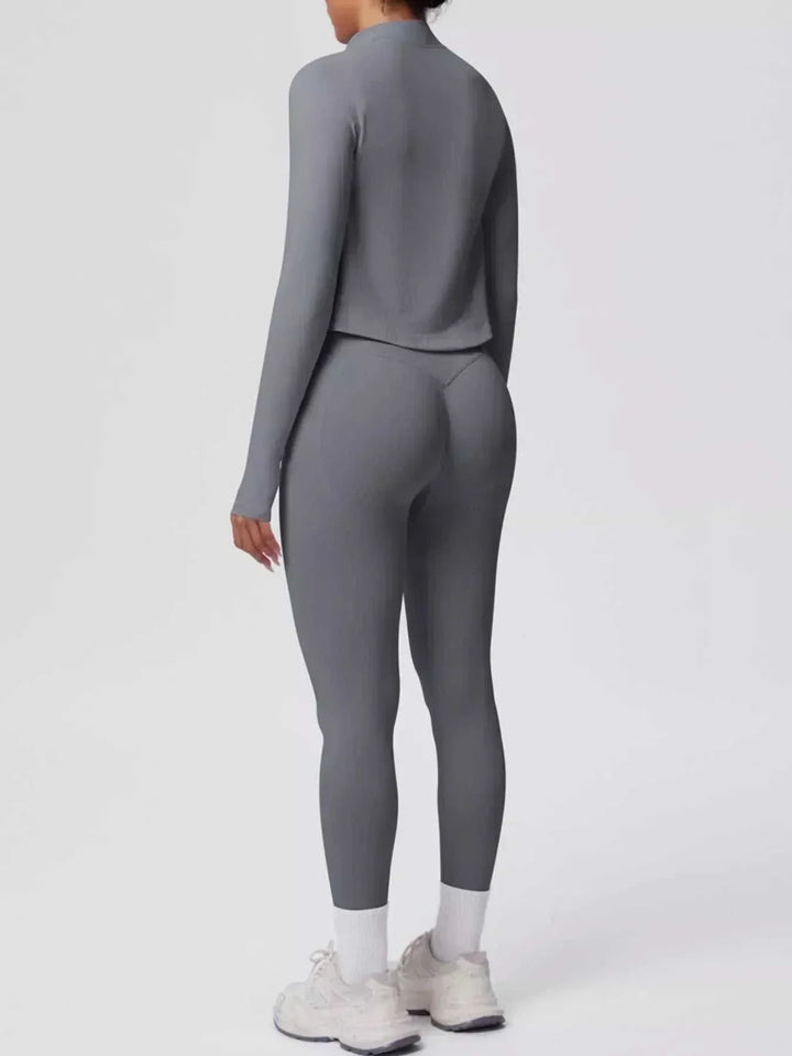 Women’s Three-Piece Activewear Set in charcoal gray stretch fabric, showing a long-sleeve cropped zip jacket and leggings