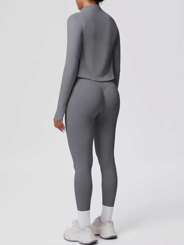 Women’s Three-Piece Activewear Set in solid charcoal gray stretch fabric, featuring a long-sleeve cropped zip-up jacket and leggings.