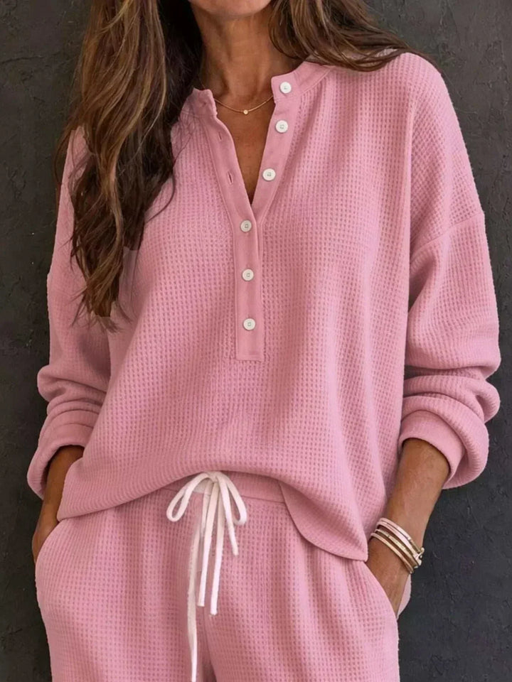Women’s Waffle Knit Set in pink textured knit, featuring a relaxed long-sleeve top with button placket and drawstring pants.