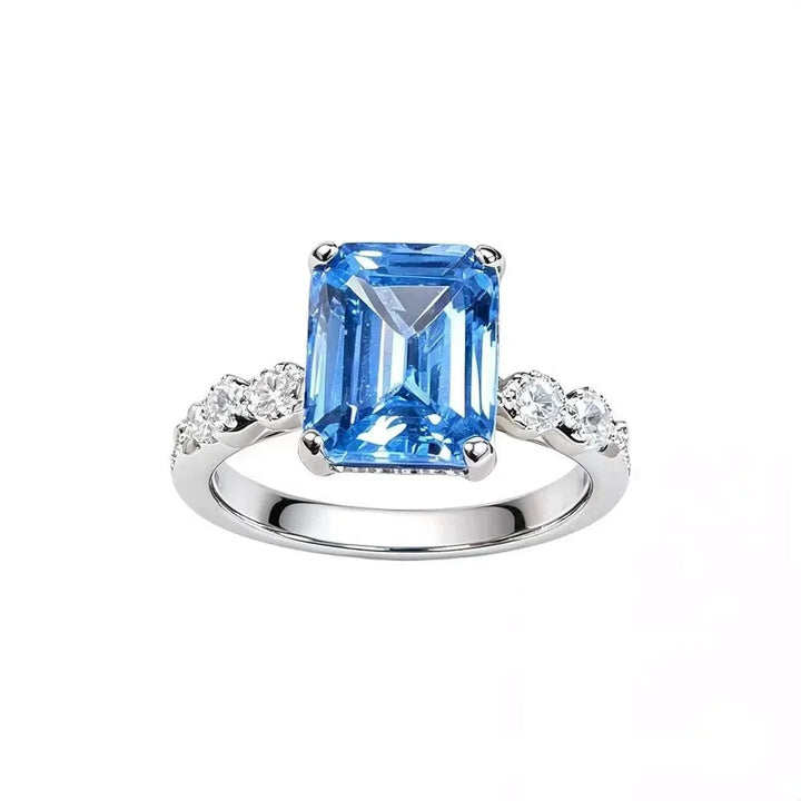 Women’s Zircon Statement Ring with a large rectangular blue gemstone, silver-tone band and sparkling clear side stones