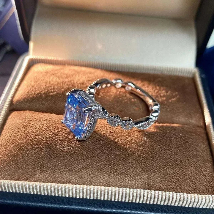 Women’s Zircon Statement Ring with a silver-tone band, clear accents and a large rectangular blue stone in a raised setting