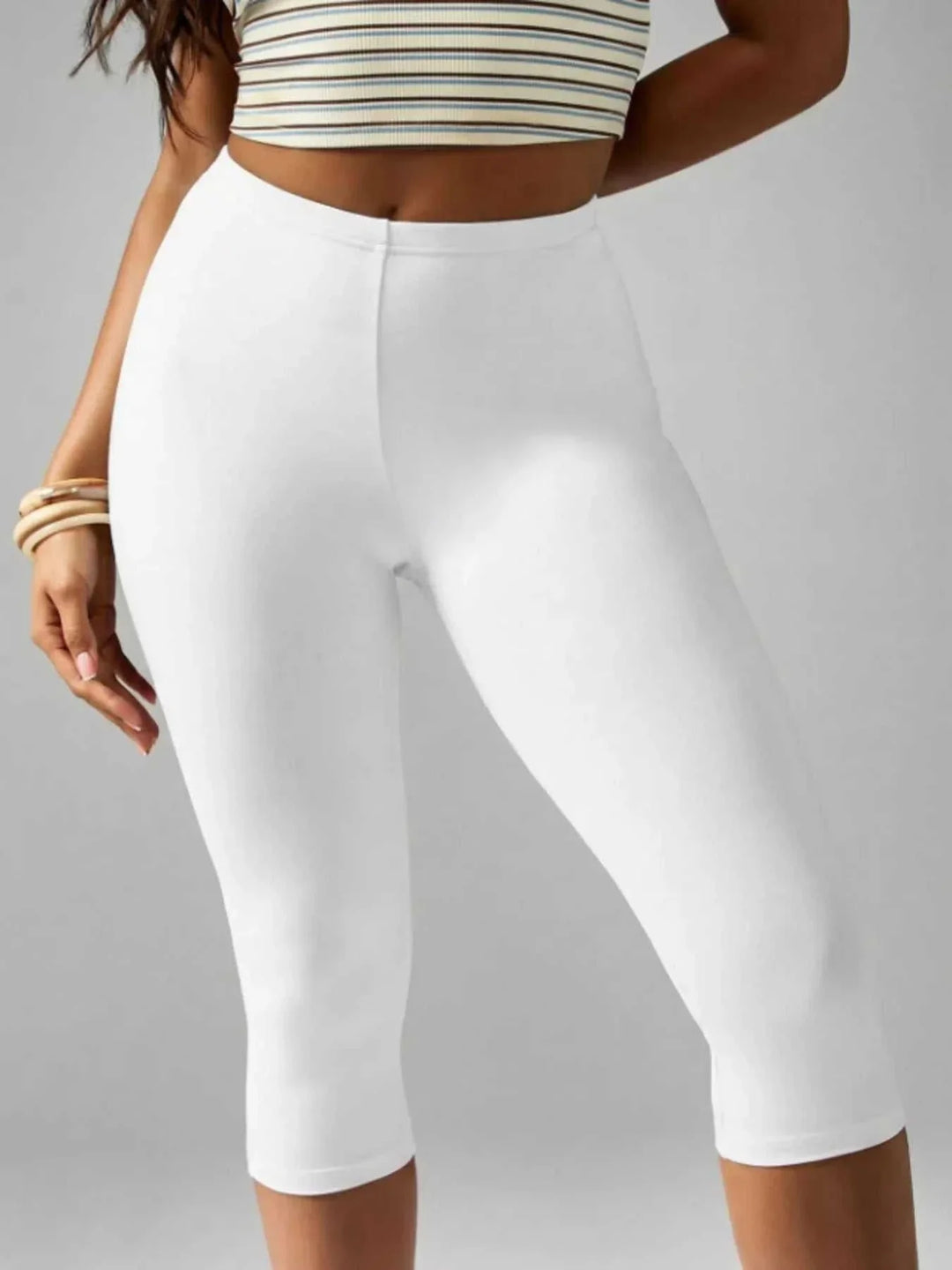 Women wearing high-waisted active capri leggings in casual sporty style