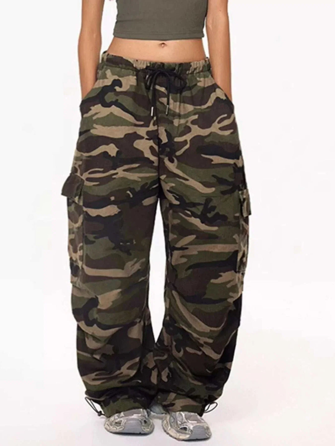 Women's camouflage cargo pants with adjustable drawstring waist in relaxed cargo-style silhouette from Hot Topic Goods