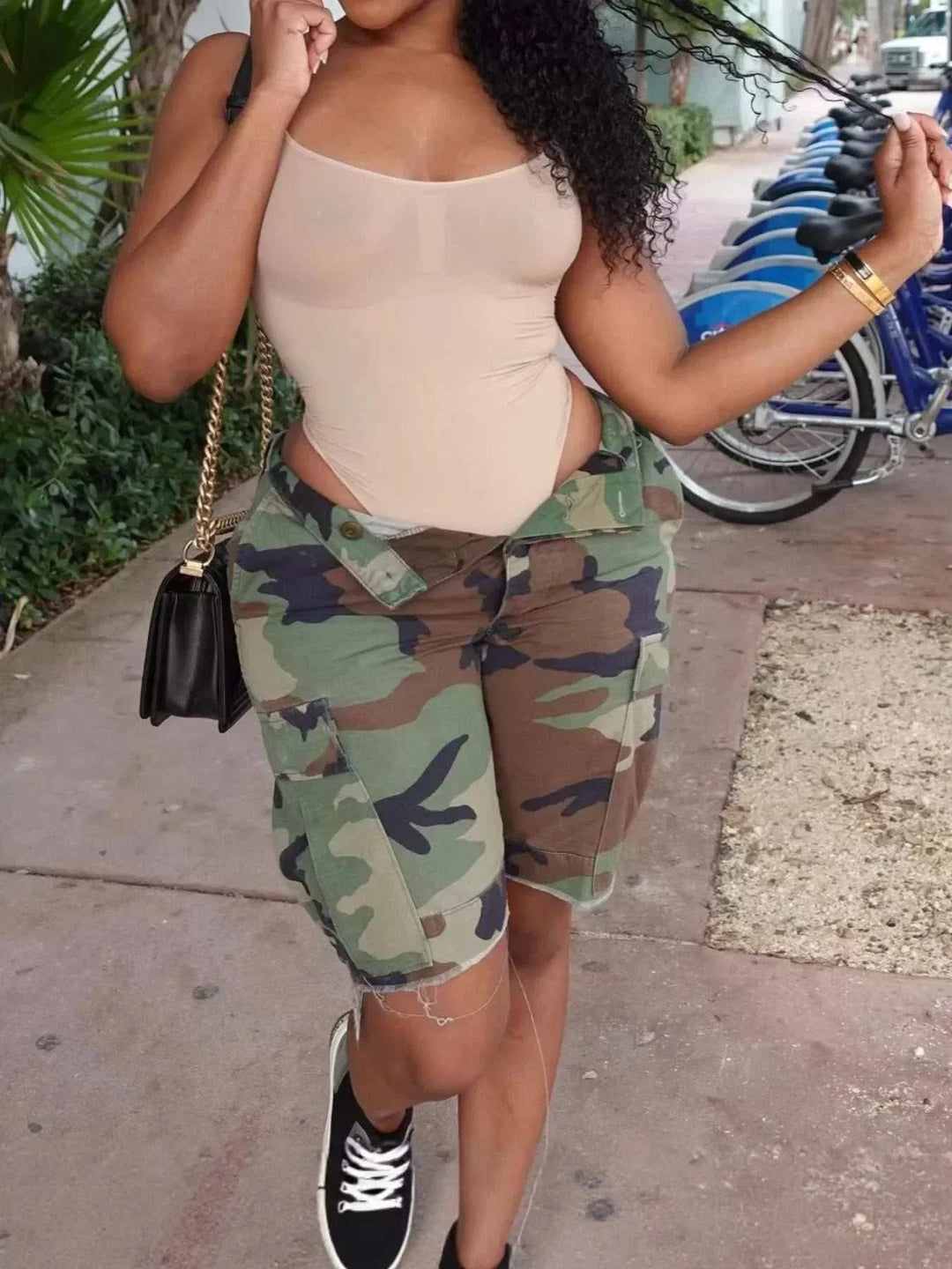 Women's camouflage cargo shorts with raw hem and utility pockets from Hot Topic Goods