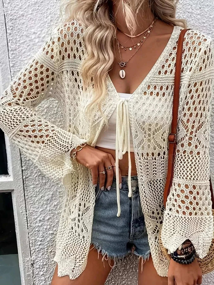Woman wearing a lightweight Women’s Crochet Tie-Front Cardigan with crochet texture and tie closure from Hot Topic Goods.