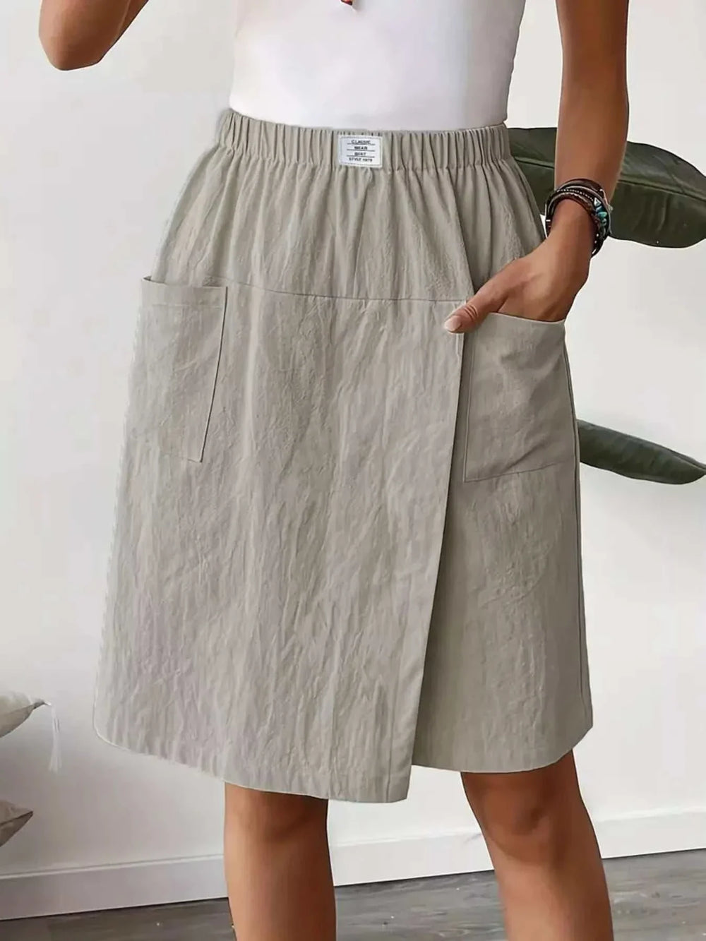 Woman wearing a women's elastic waist wrap skort with drawstring from Hot Topic Goods in casual warm-weather outfit