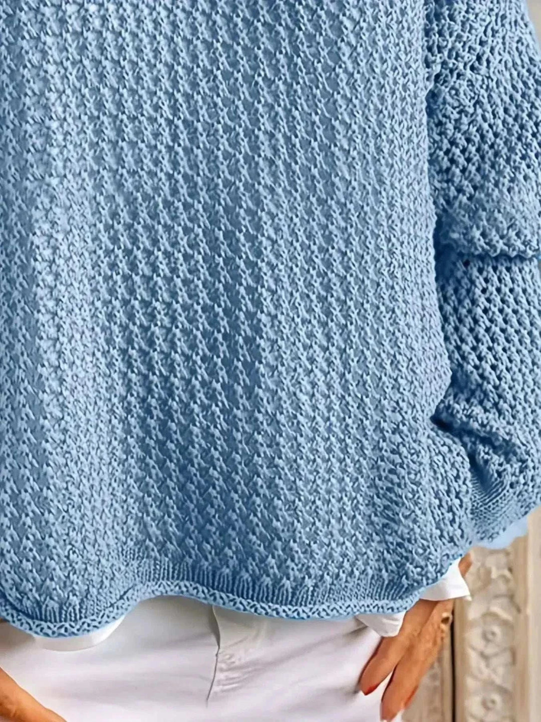 Woman wearing a lightweight openwork knit hooded cover-up with long sleeves from Hot Topic Goods, styled over swimwear for beach and resort wear