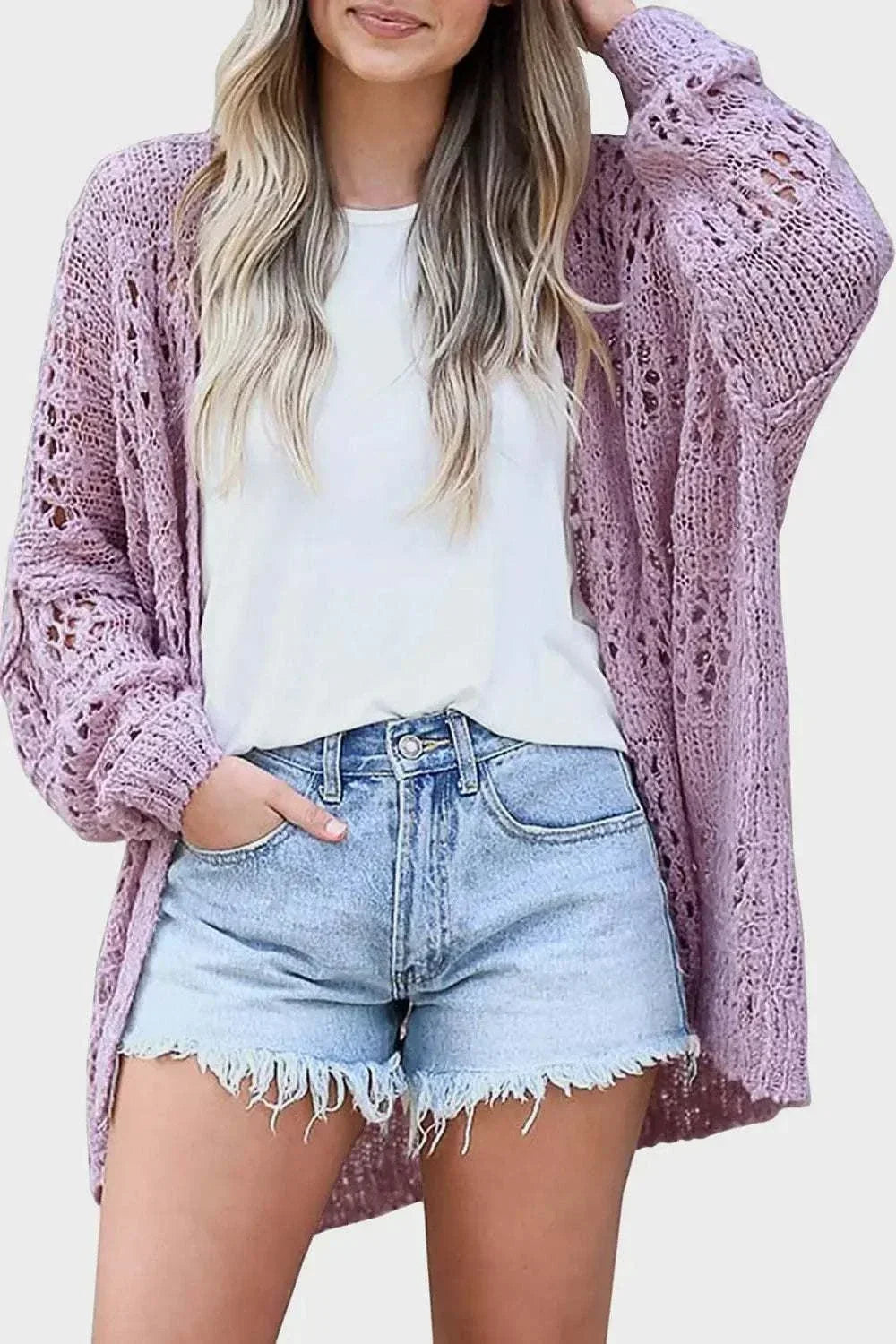 Women wearing a lightweight open-front long sleeve cardigan with openwork texture from Hot Topic Goods