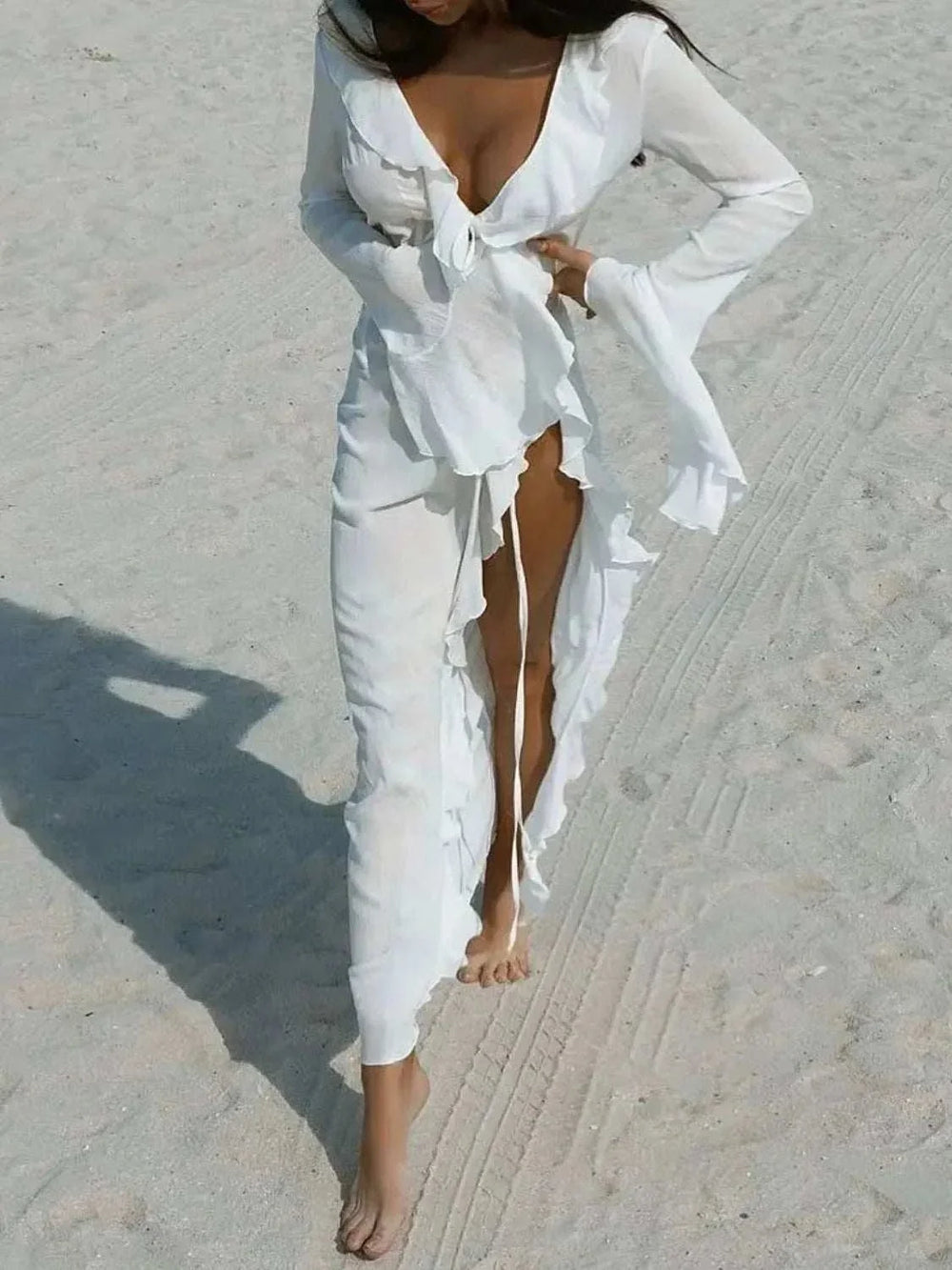 Woman wearing a Women's Ruffled Cover-Up Dress from Hot Topic Goods with long sleeves and feminine ruffle detailing at the beach