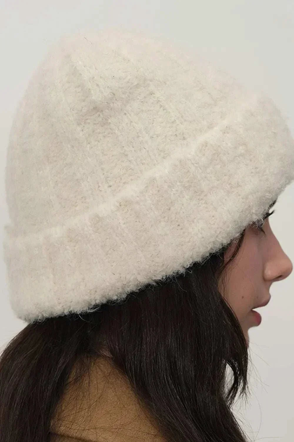 Women’s solid-color thermal knit winter hat by Hot Topic Goods with cozy fur material and classic design for cold weather