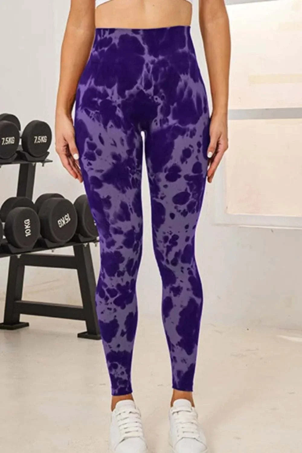 Women wearing colorful tie-dye active leggings with high-waist fit from Hot Topic Goods in casual outdoor setting