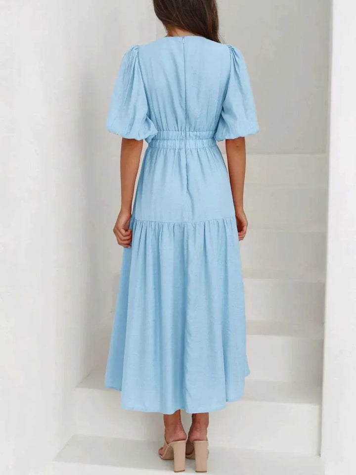 Woman wearing a V-Neck Puff Sleeve Midi Dress with puff sleeves and midi length from Hot Topic Goods