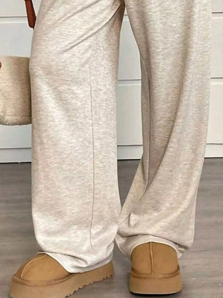 Woman wearing high-waisted wide-leg drawstring pants from Hot Topic Goods in casual setting