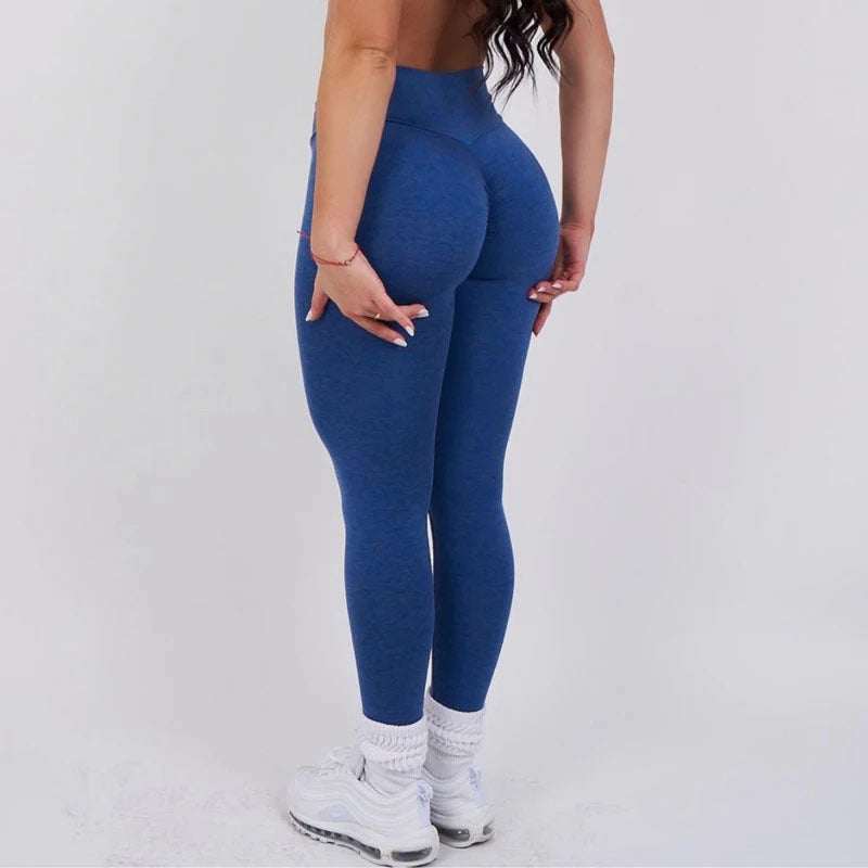 Woman wearing high-waist moisture-wicking yoga workout leggings from Hot Topic Goods
