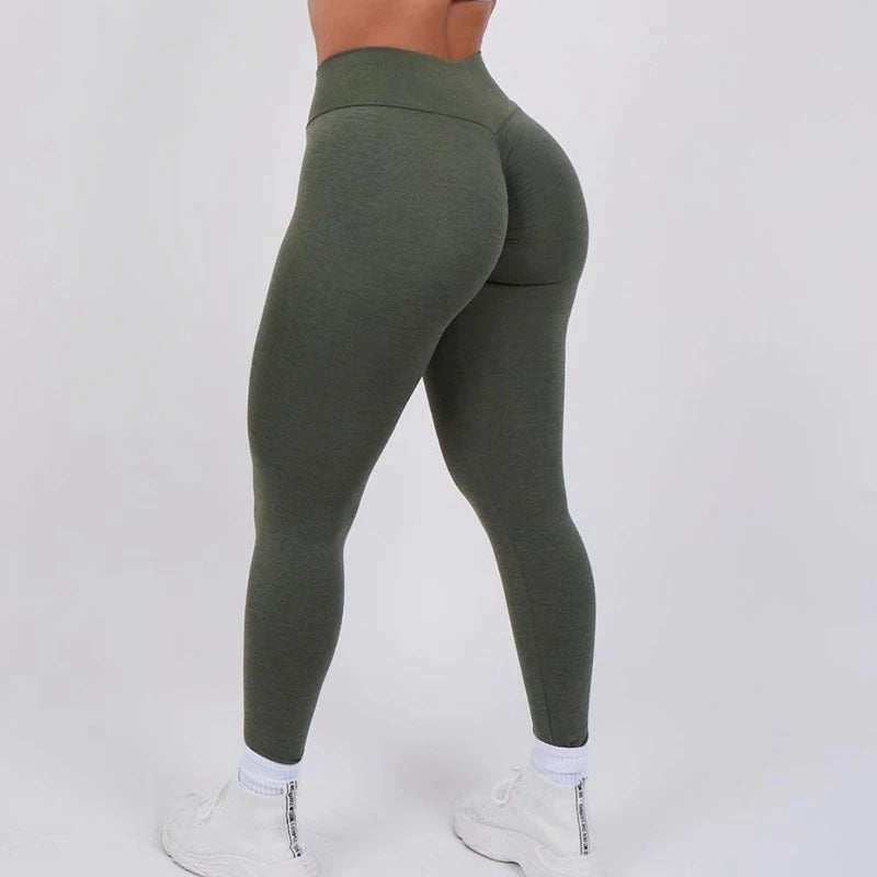Female model wearing high-waisted moisture-wicking women's yoga workout leggings from Hot Topic Goods in a sleek fitted style
