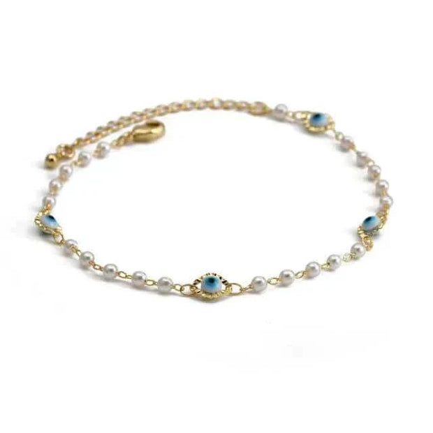 Stylish charm bracelet with pearls and blue gemstone accents.