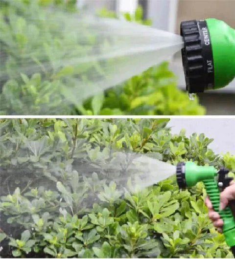 Flexible garden hose spraying water on green plants.