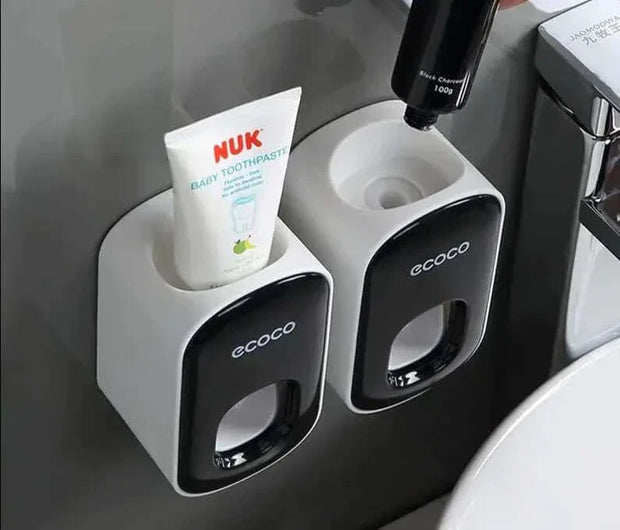 Automatic toothpaste dispenser with wall-mount design and toothbrush holder.