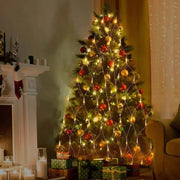 Christmas tree adorned with Net Mesh Solar Fairy Lights in a cozy indoor setting.