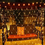 Net Mesh Solar Fairy Lights illuminating an outdoor seating area with warm white LED glow.